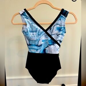 Lucky Leo brand women’s size xs leotard. Black bottom, white/blue swirl top.